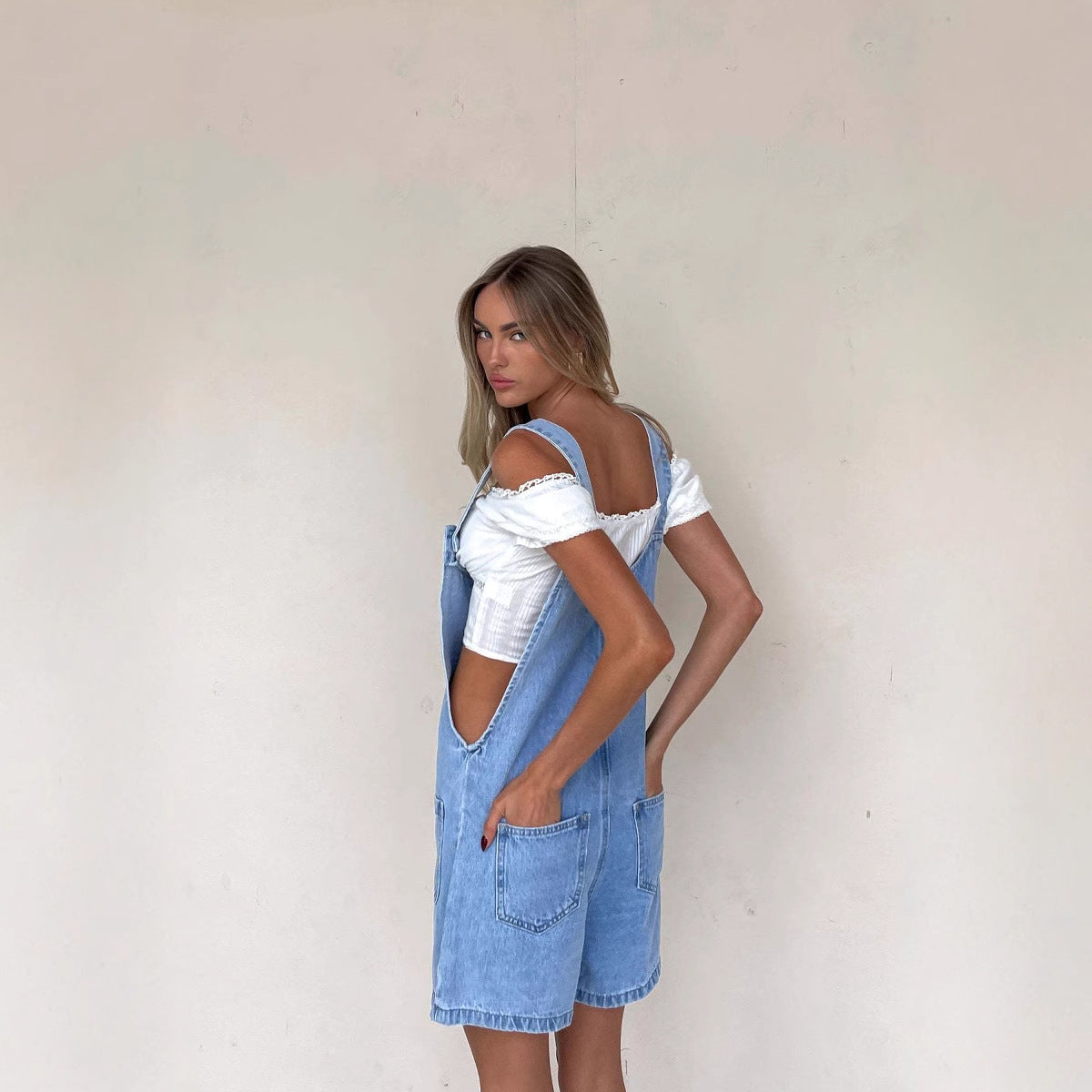 Women's denim overalls with practical pockets and button-down design