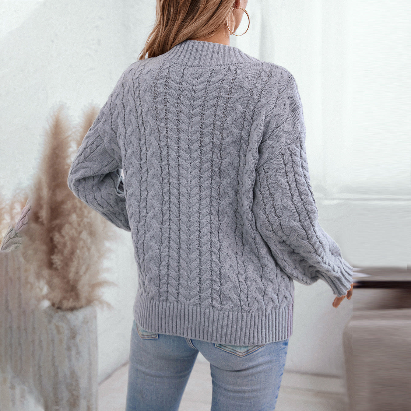 Women's chunky knit pullover with V-neck and cable pattern