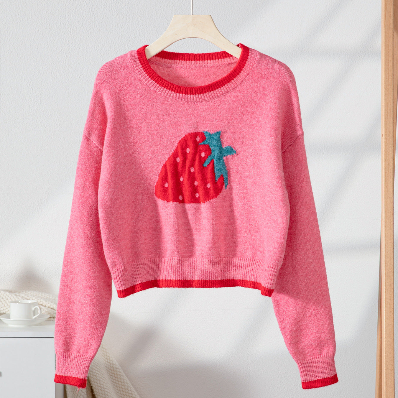 Women’s trendy pullover with strawberry motif and contrast cuffs