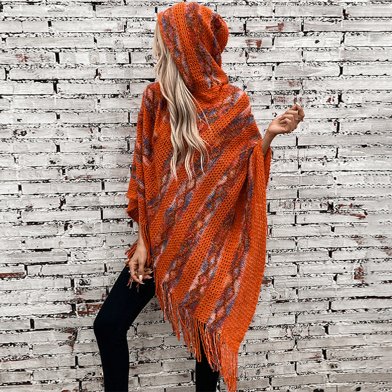 Ladies knit poncho with hood and fringed design