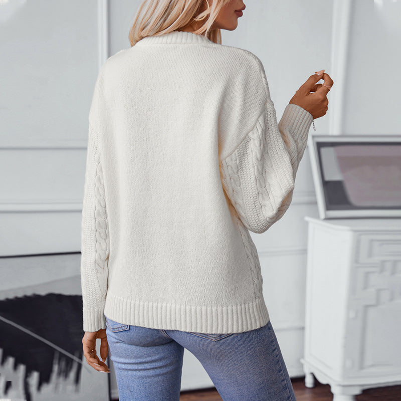 Women's knitted pullover with cable pattern and high cuffs