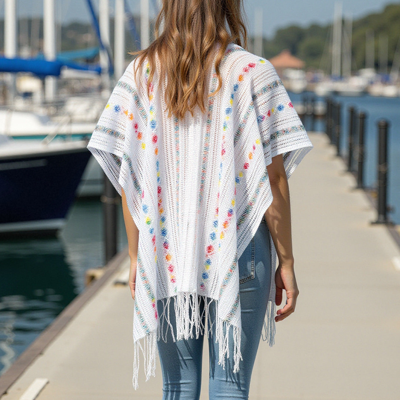 Women’s casual poncho with fringed details and colorful patterns