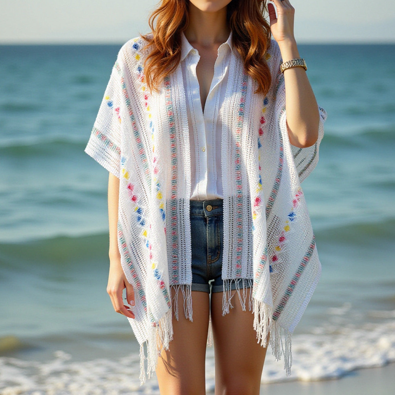 Women’s casual poncho with fringed details and colorful patterns