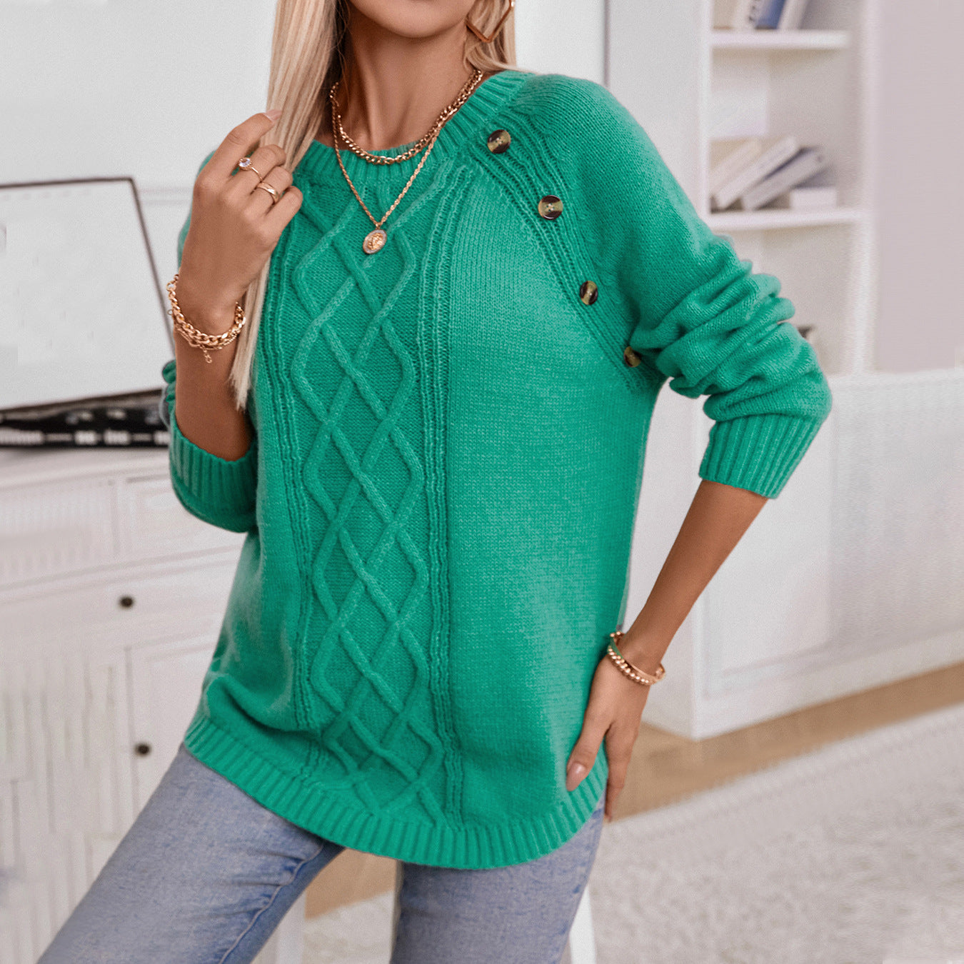 Women's knitted pullover with decorative cable pattern and button details