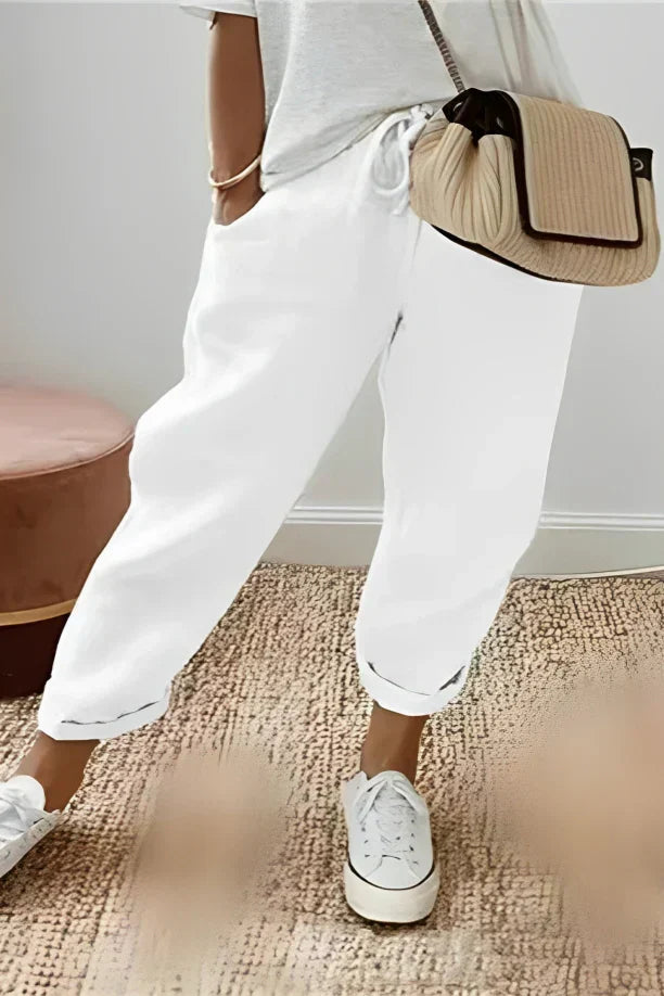 Pants with drawstring and diagonal pocket