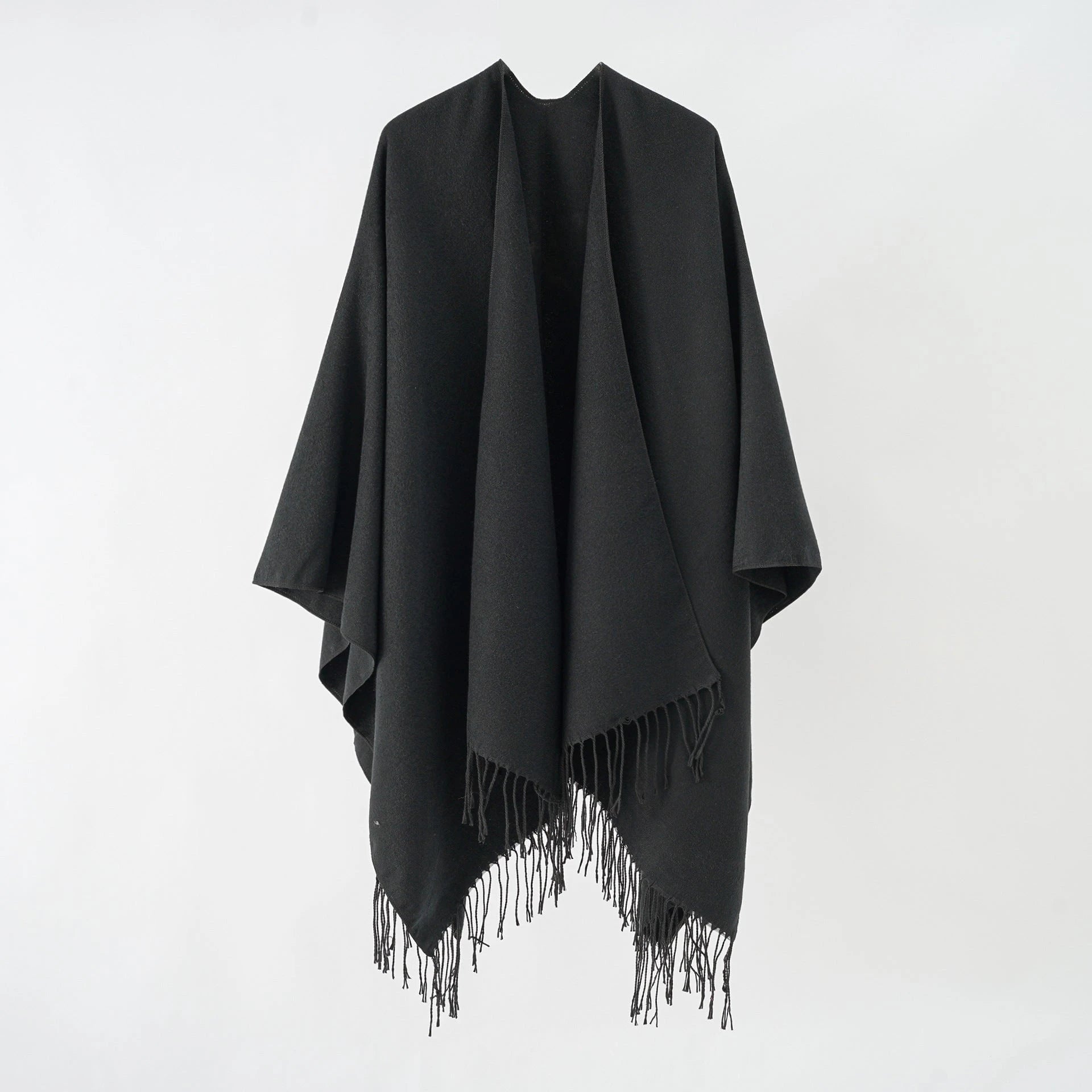 Women's stylish fringe poncho made from soft material with a luxurious drape