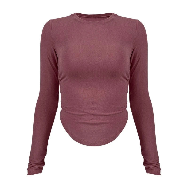 Ladies long-sleeved functional top with stylish gathering elements and figure-hugging cut
