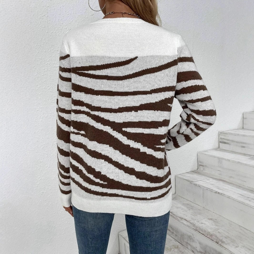 Ladies cozy knitted pullover with modern zebra stripe pattern and comfortable fit