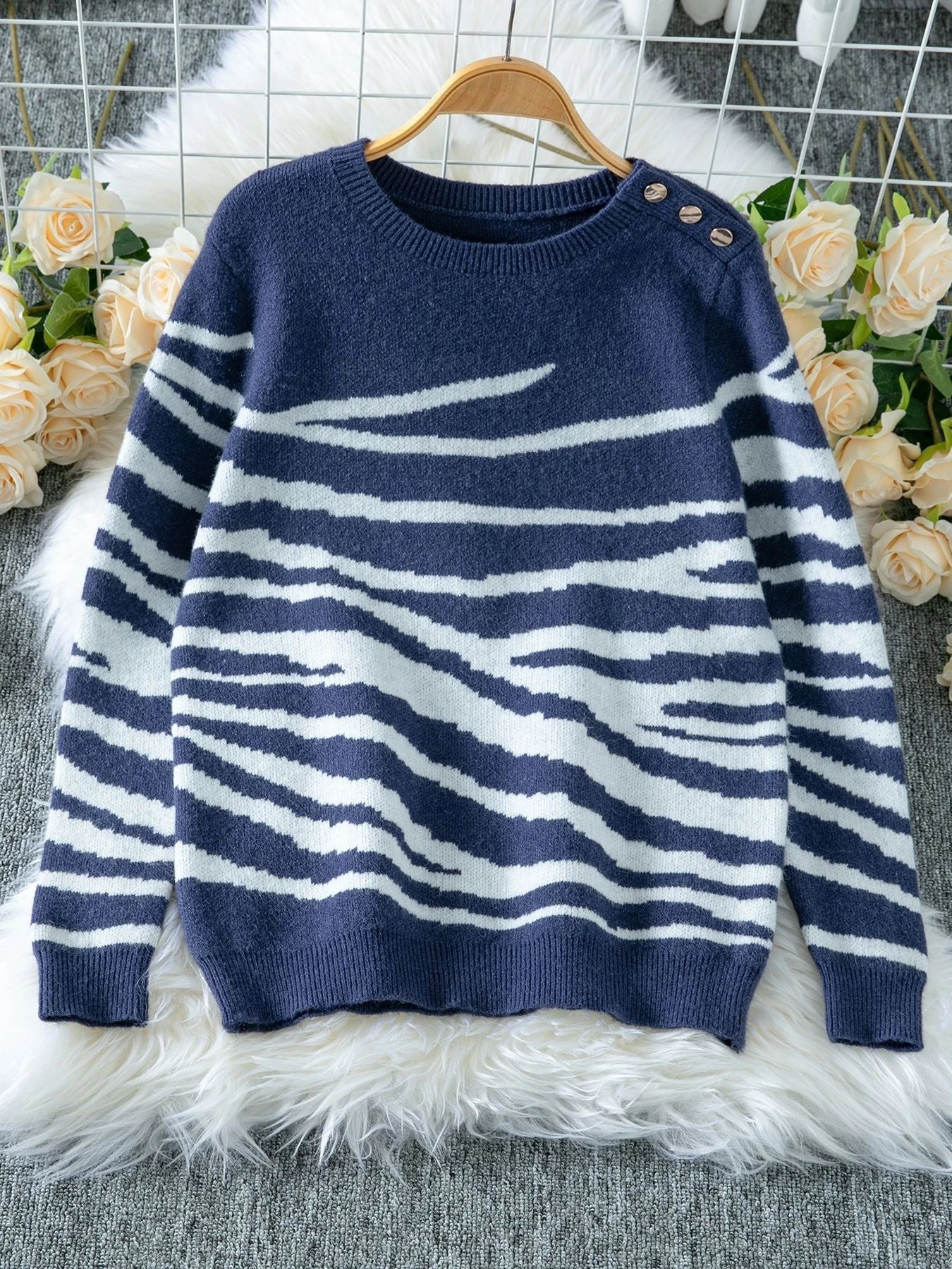 Ladies cozy knitted pullover with modern zebra stripe pattern and comfortable fit