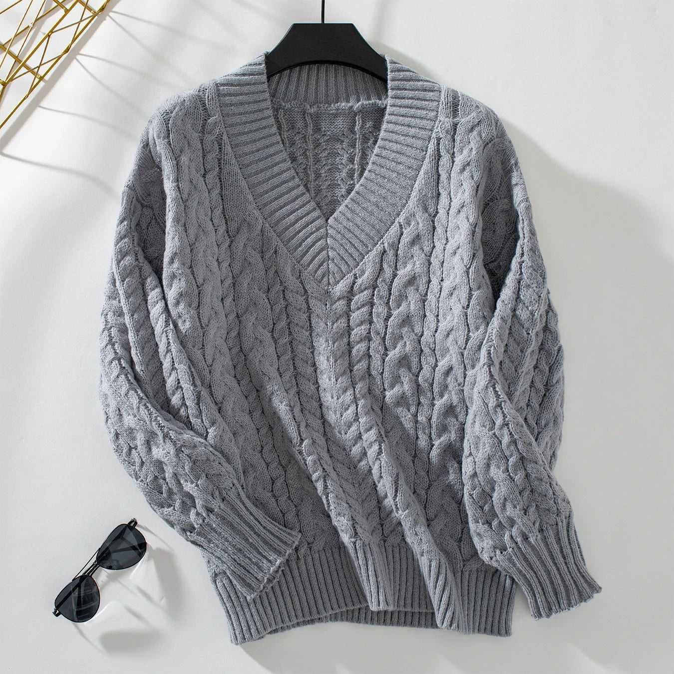 Women's chunky knit pullover with V-neck and cable pattern