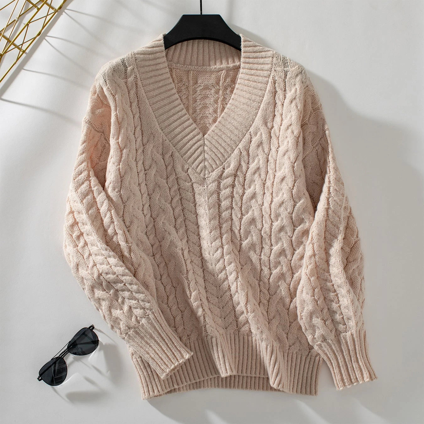 Women's chunky knit pullover with V-neck and cable pattern