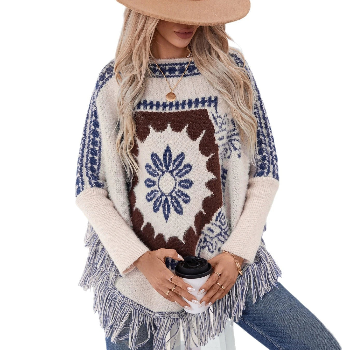 Ladies elegant knitted poncho with artistic pattern and fringed hem