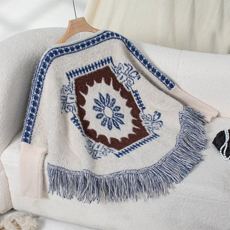 Ladies elegant knitted poncho with artistic pattern and fringed hem