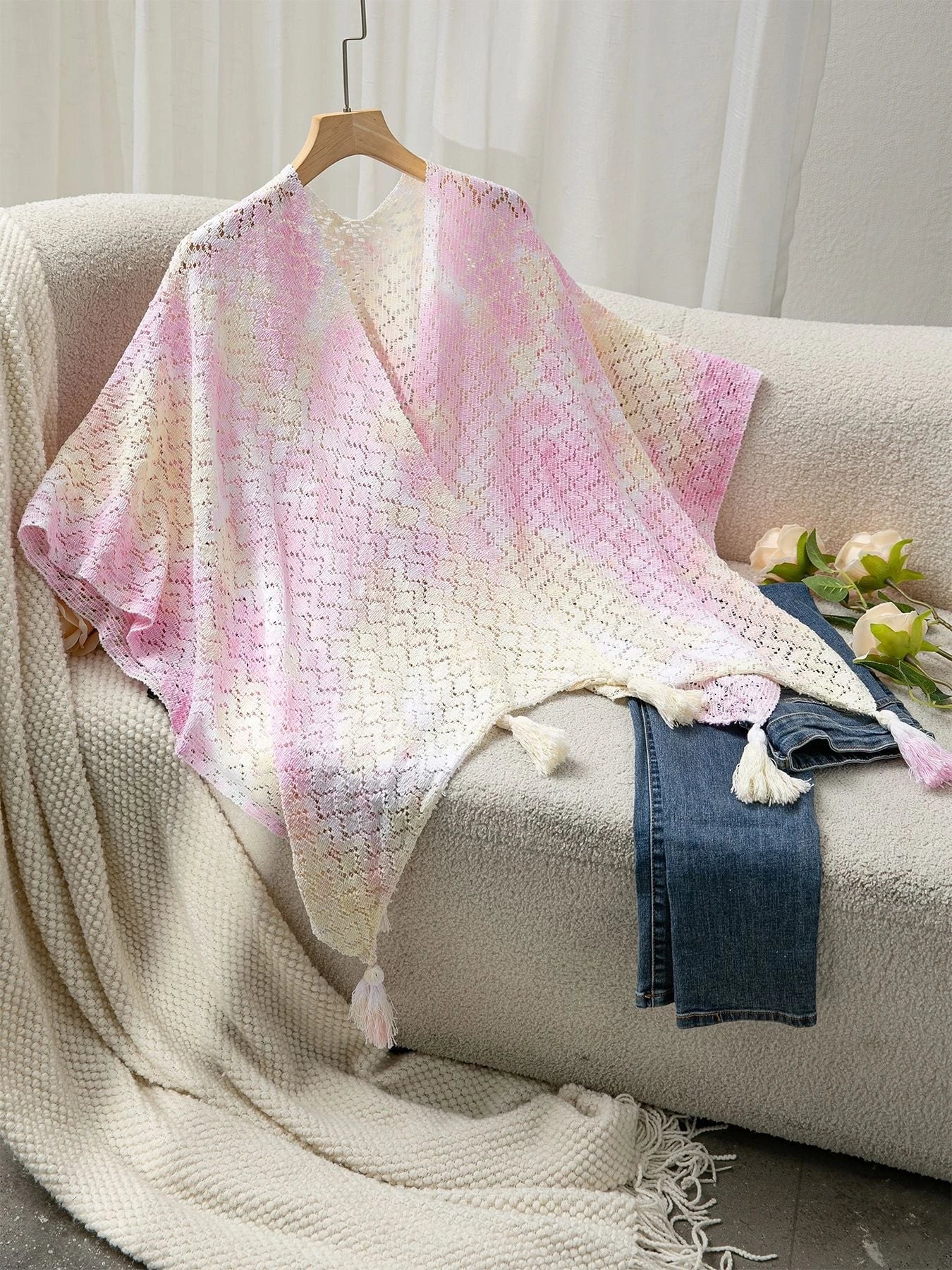 Ladies airy knitted poncho with decorative tassels