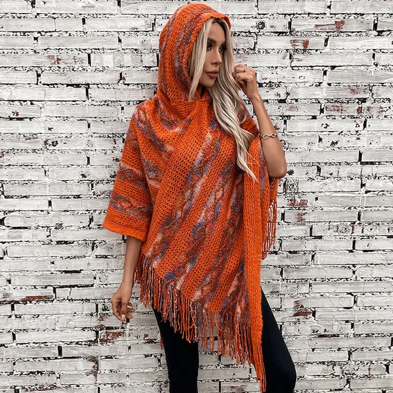 Ladies knit poncho with hood and fringed design