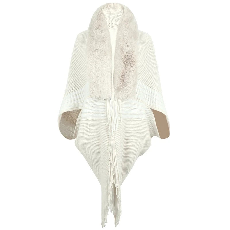 Women's elegant knitted poncho with faux fur trimmed collar and fringes