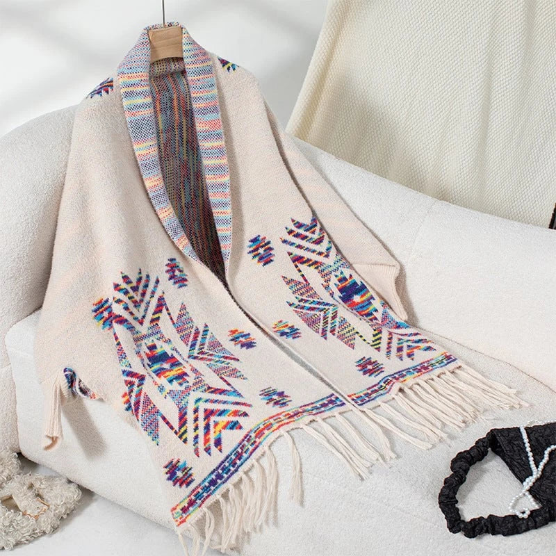 Women’s knitted poncho with colorful Navajo pattern and fringed hem