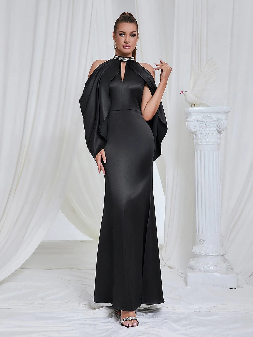 Ladies evening dress with shimmering cape design and elegant closure detail