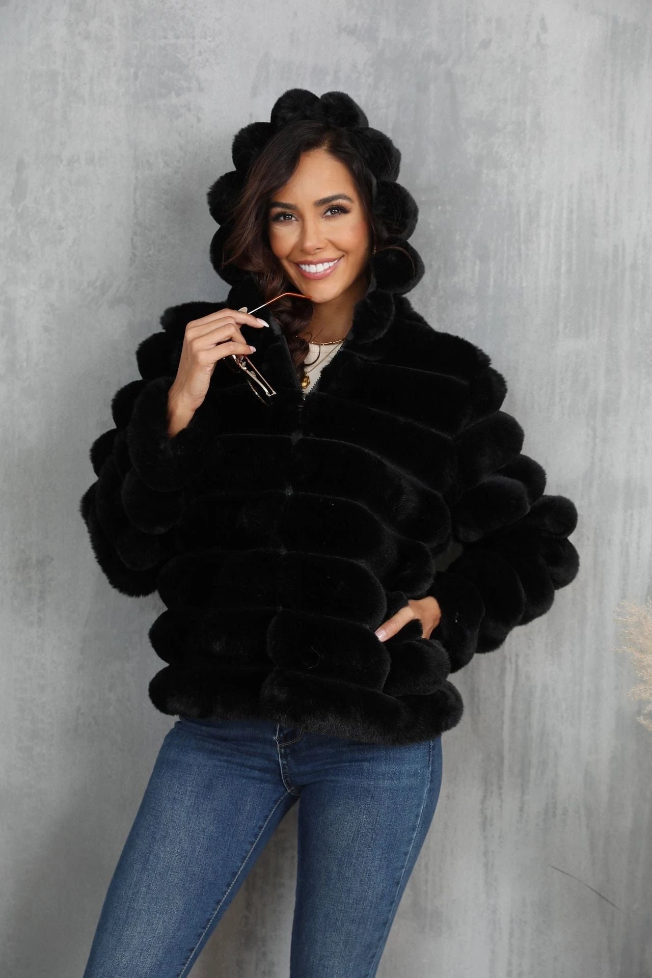 Women's stylish hooded jacket made of faux fur with a textured pattern