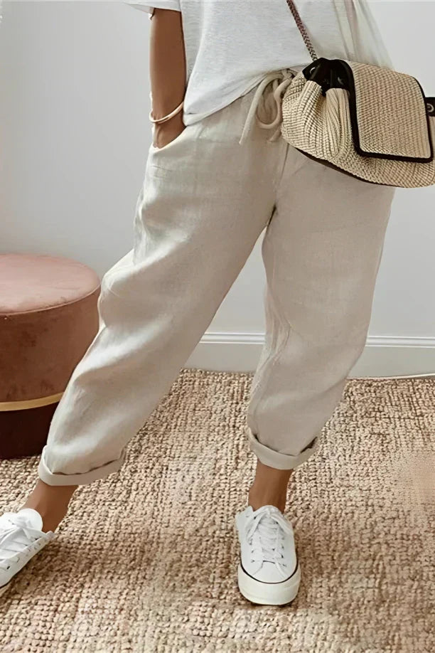 Pants with drawstring and diagonal pocket