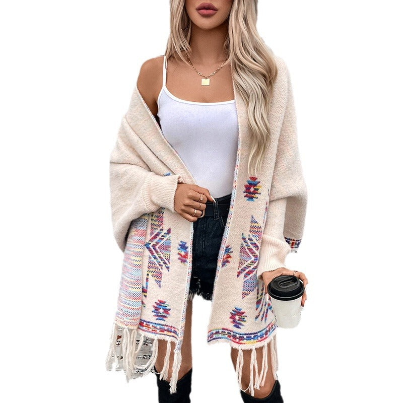Women’s knitted poncho with colorful Navajo pattern and fringed hem