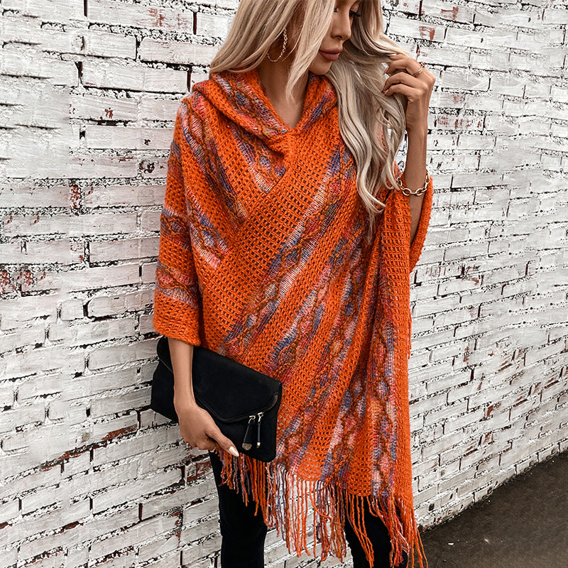 Ladies knit poncho with hood and fringed design