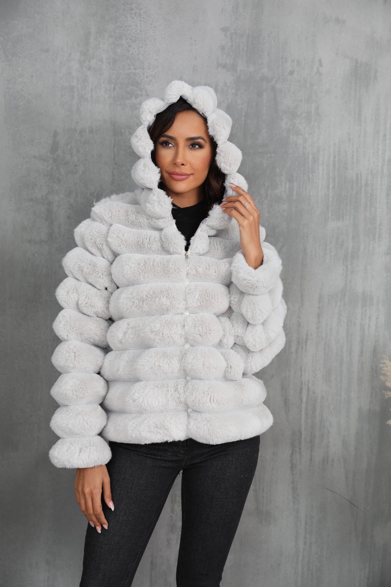 Women's stylish hooded jacket made of faux fur with a textured pattern