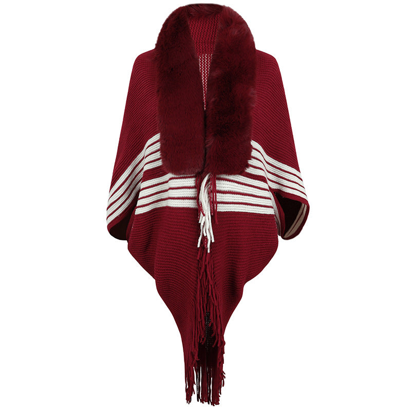 Women's elegant knitted poncho with faux fur trimmed collar and fringes