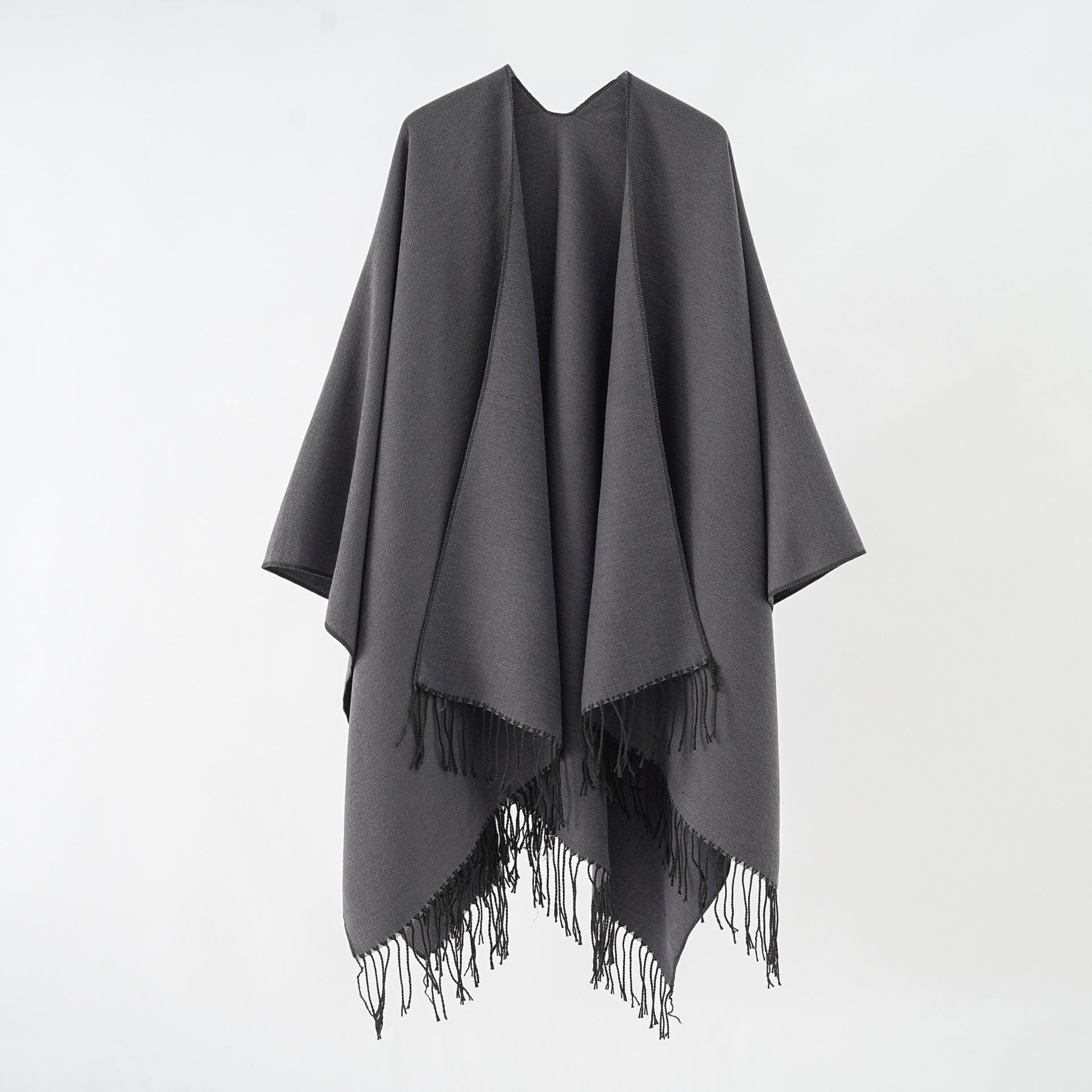 Women's stylish fringe poncho made from soft material with a luxurious drape