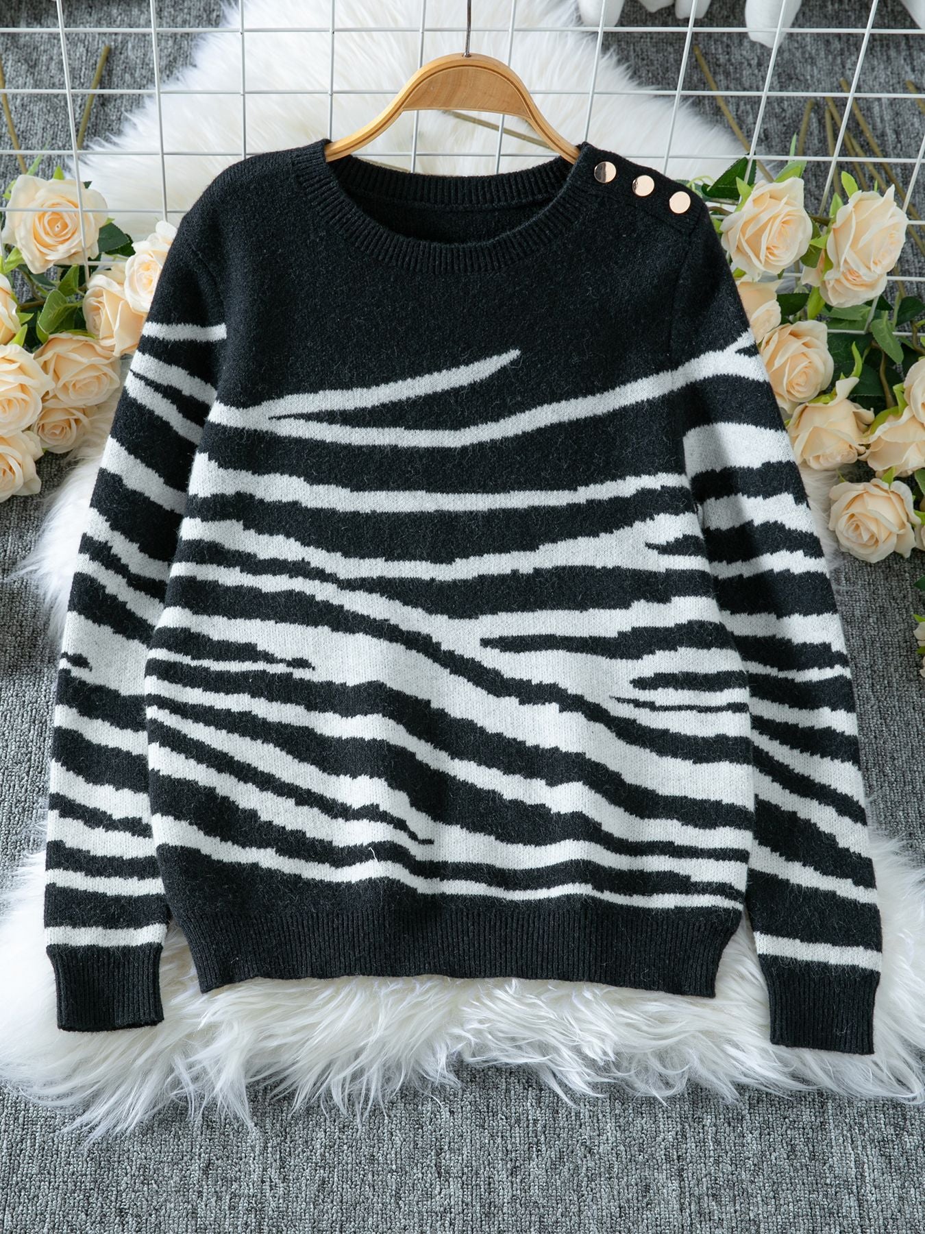 Ladies cozy knitted pullover with modern zebra stripe pattern and comfortable fit