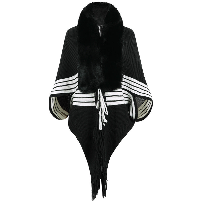 Women's elegant knitted poncho with faux fur trimmed collar and fringes