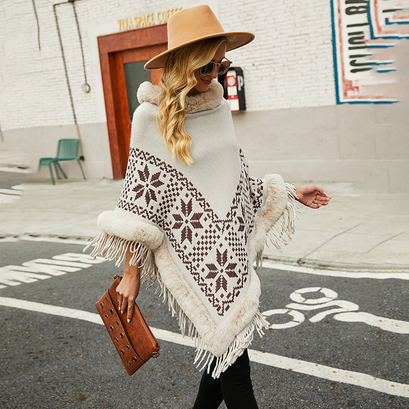 Ladies elegant poncho with decorative fringe design and faux fur trim