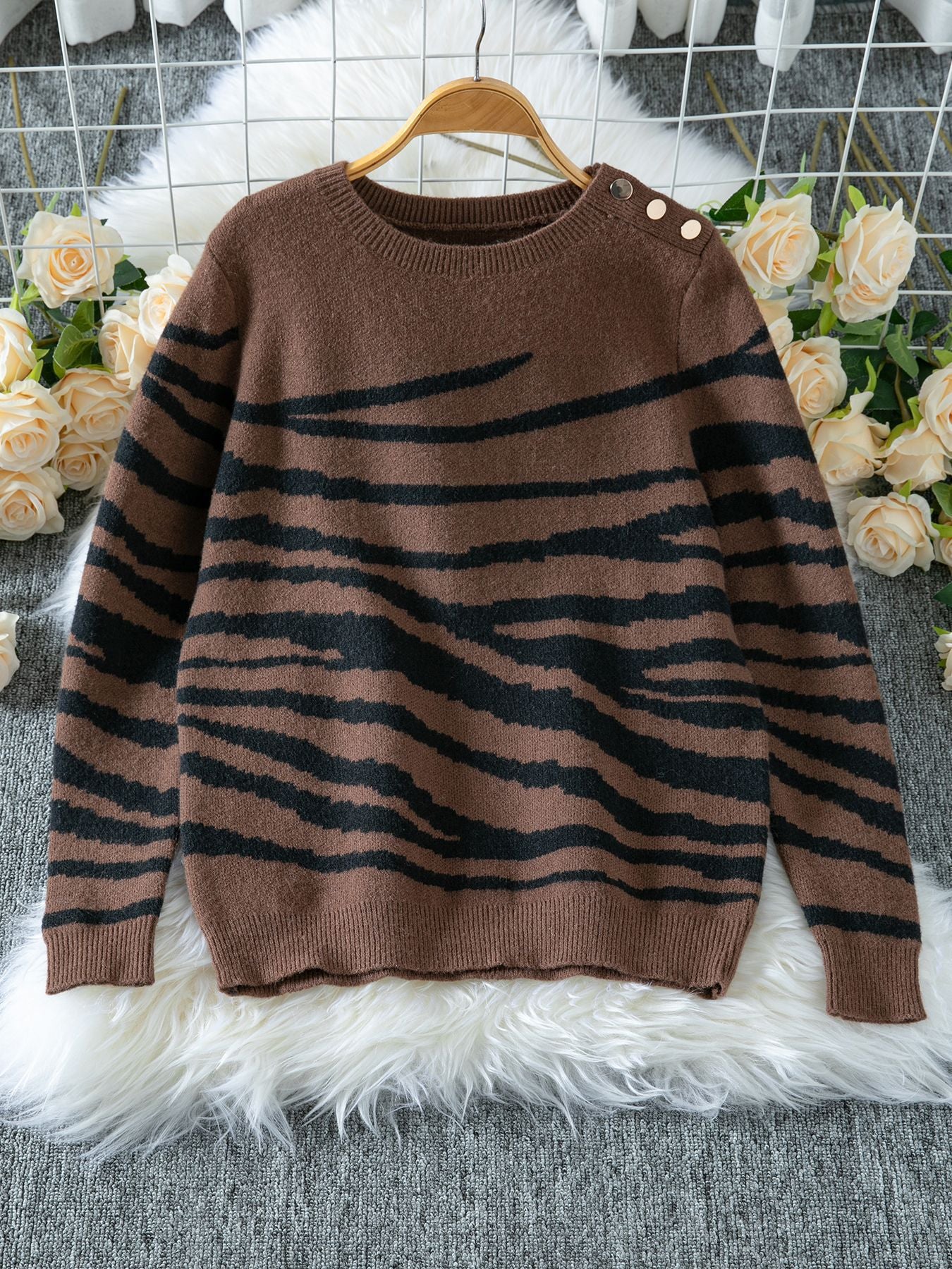 Ladies cozy knitted pullover with modern zebra stripe pattern and comfortable fit