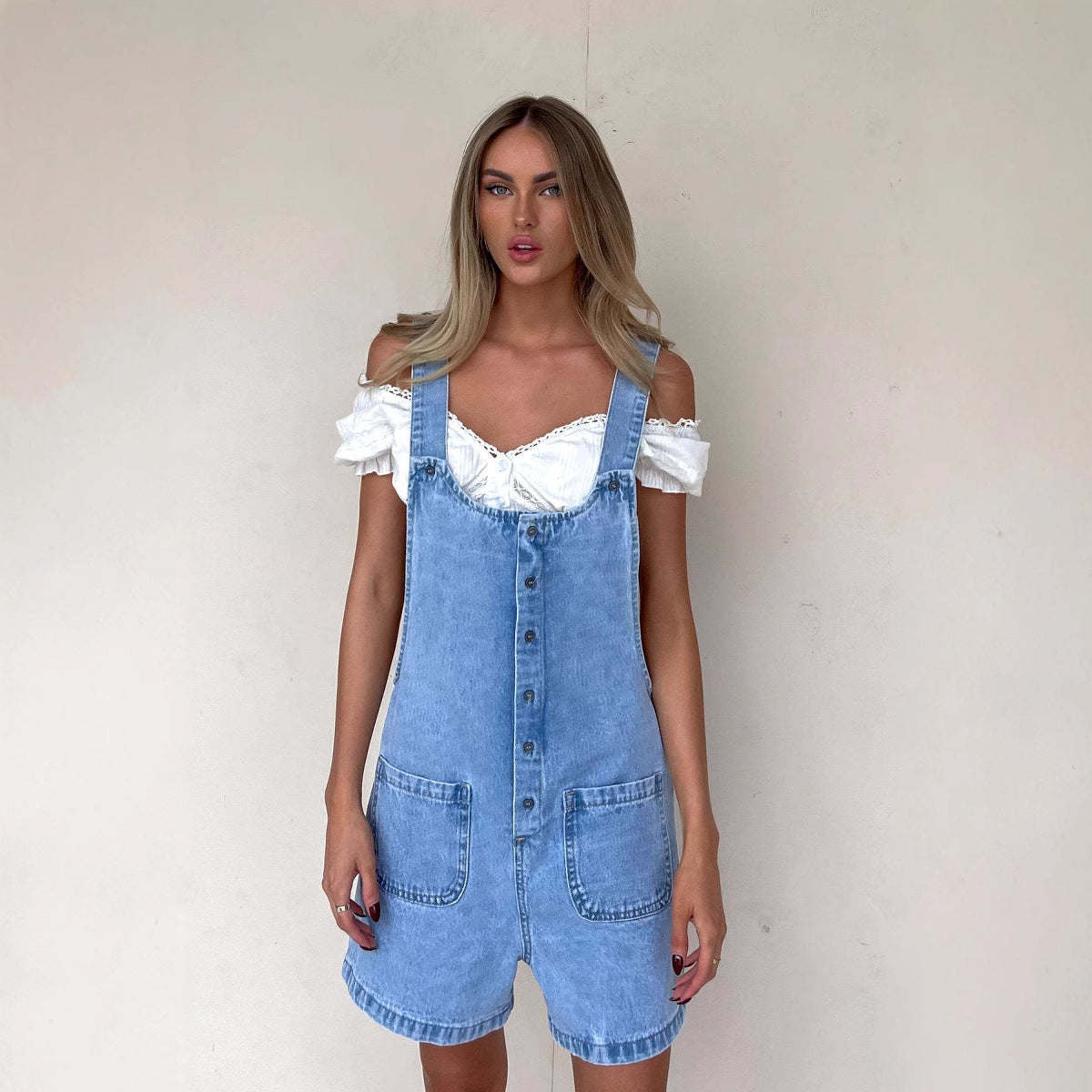 Women's denim overalls with practical pockets and button-down design