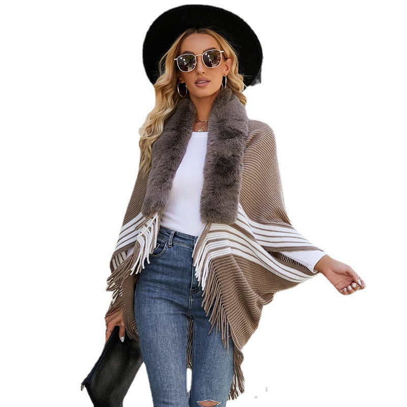 Women's elegant knitted poncho with faux fur trimmed collar and fringes
