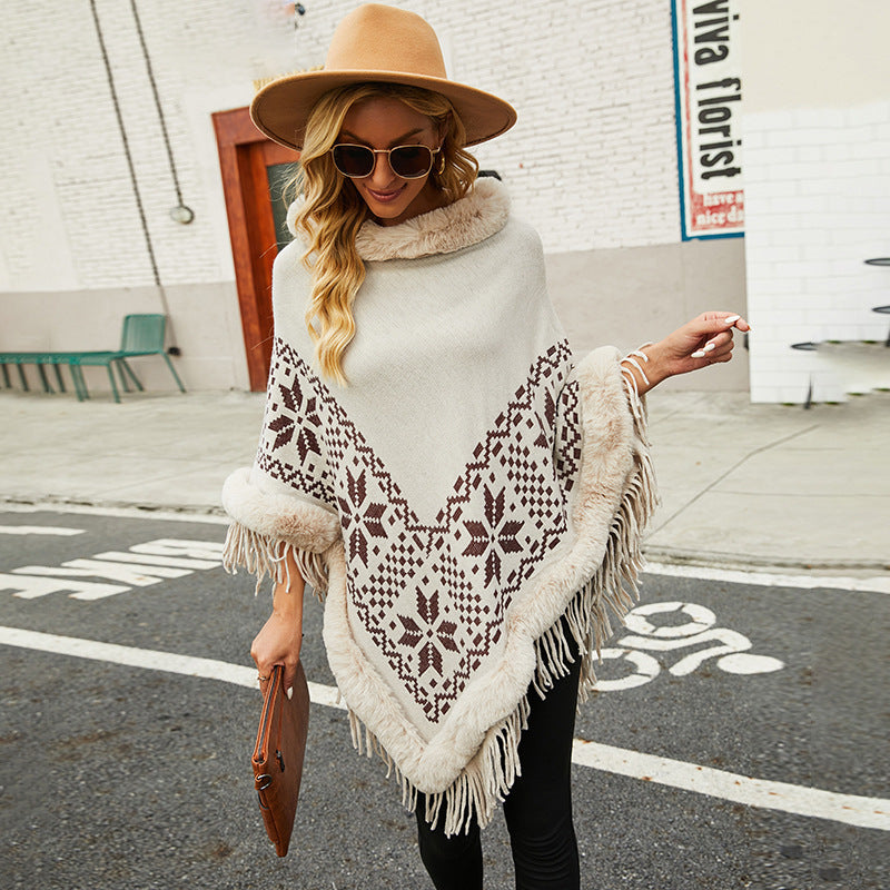 Ladies elegant poncho with decorative fringe design and faux fur trim