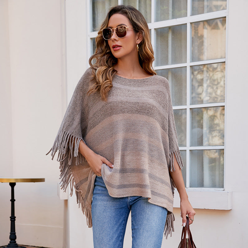 Ladies elegant poncho with textured design and fringed details