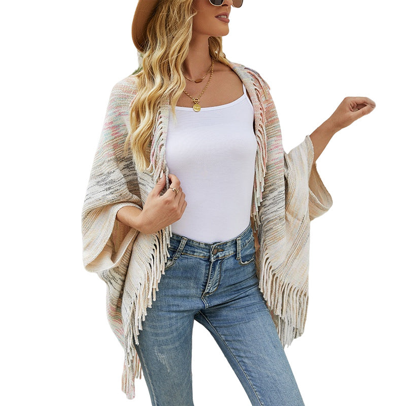 Ladies fashionable poncho with fringed hem and textured design