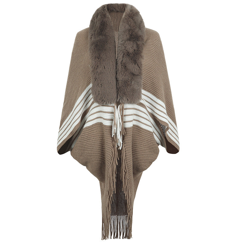 Women's elegant knitted poncho with faux fur trimmed collar and fringes