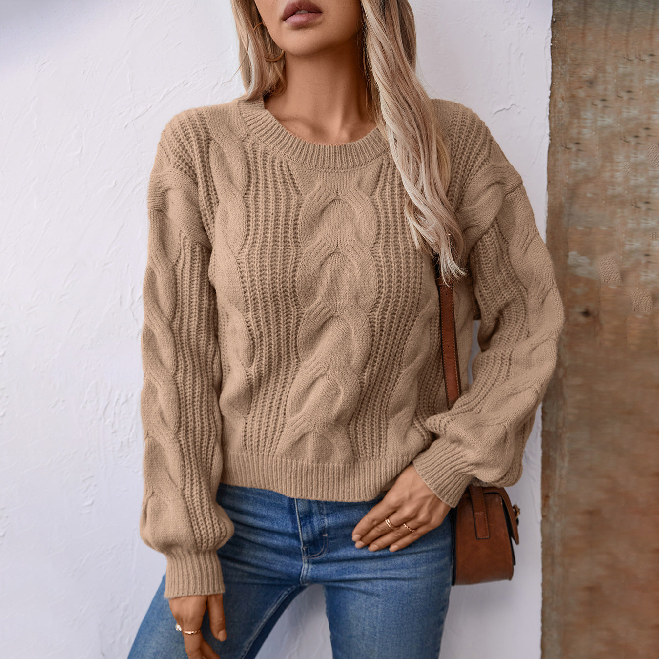 Women's chunky knit pullover with voluminous sleeves and cable pattern