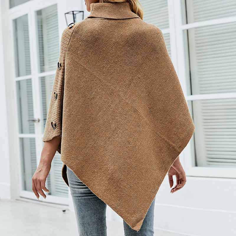 Women's oversized poncho with high collar and decorative button details