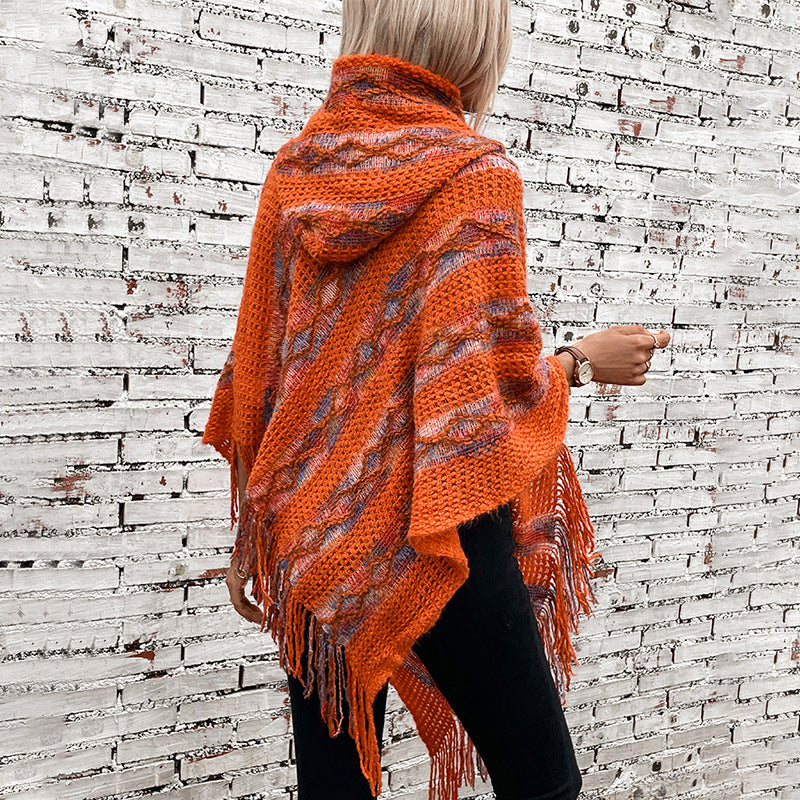 Ladies knit poncho with hood and fringed design