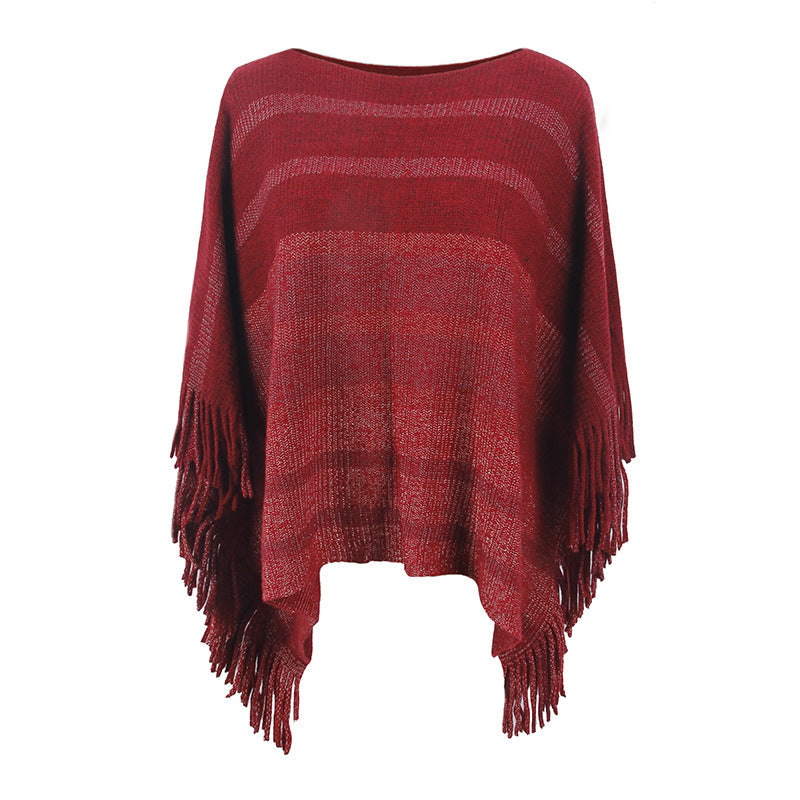 Ladies elegant poncho with textured design and fringed details