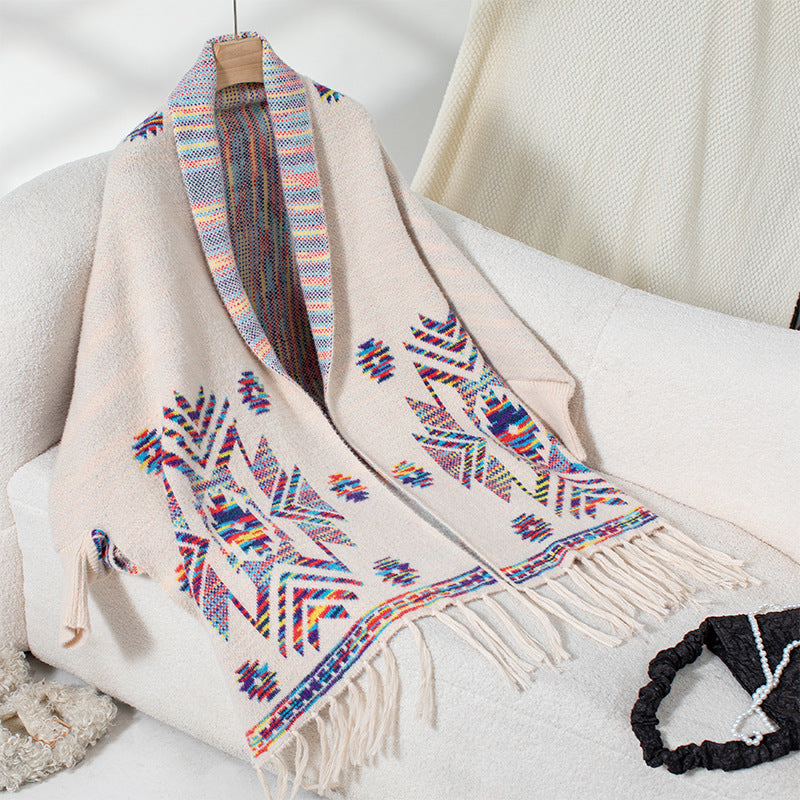 Women’s knitted poncho with colorful Navajo pattern and fringed hem