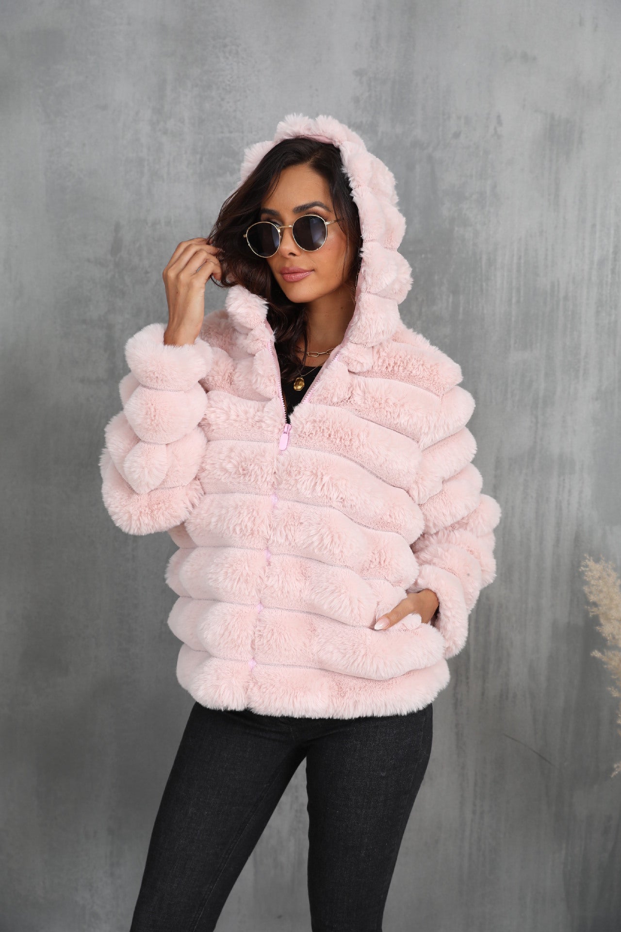 Women's stylish hooded jacket made of faux fur with a textured pattern