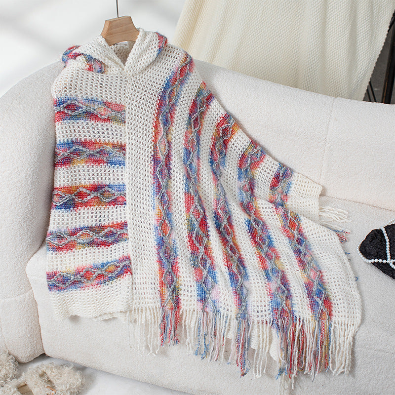 Ladies knit poncho with hood and fringed design
