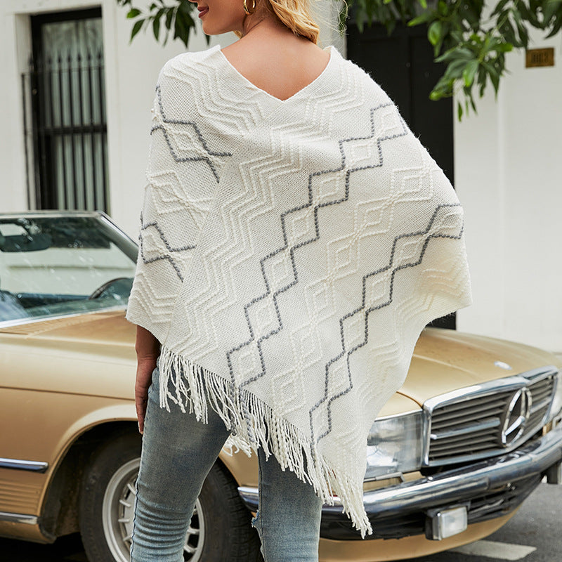 Ladies elegant poncho with eye-catching textured pattern and decorative fringes