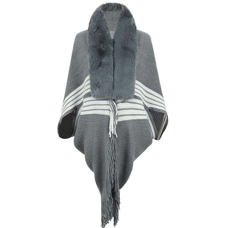 Women's elegant knitted poncho with faux fur trimmed collar and fringes