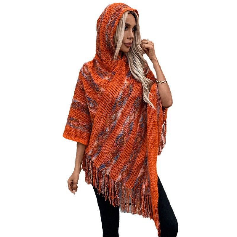 Ladies knit poncho with hood and fringed design