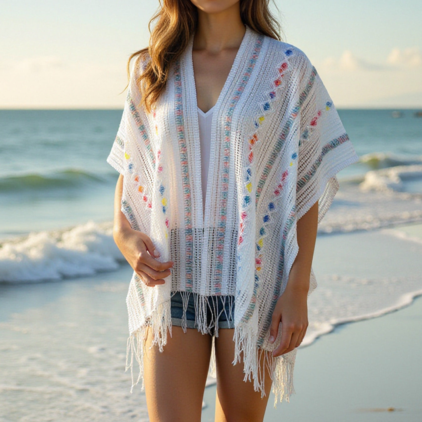 Women’s casual poncho with fringed details and colorful patterns
